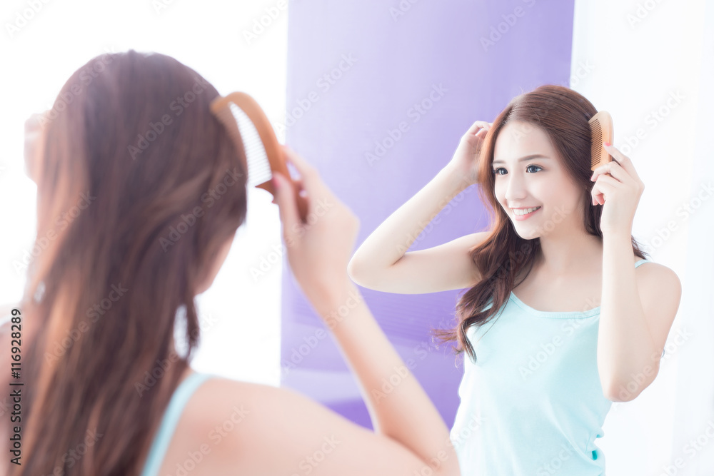 young woman is combing hair