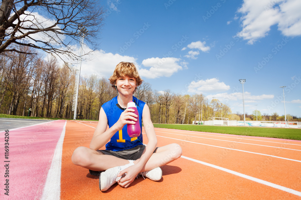 Teenage sportsman having rest after working out