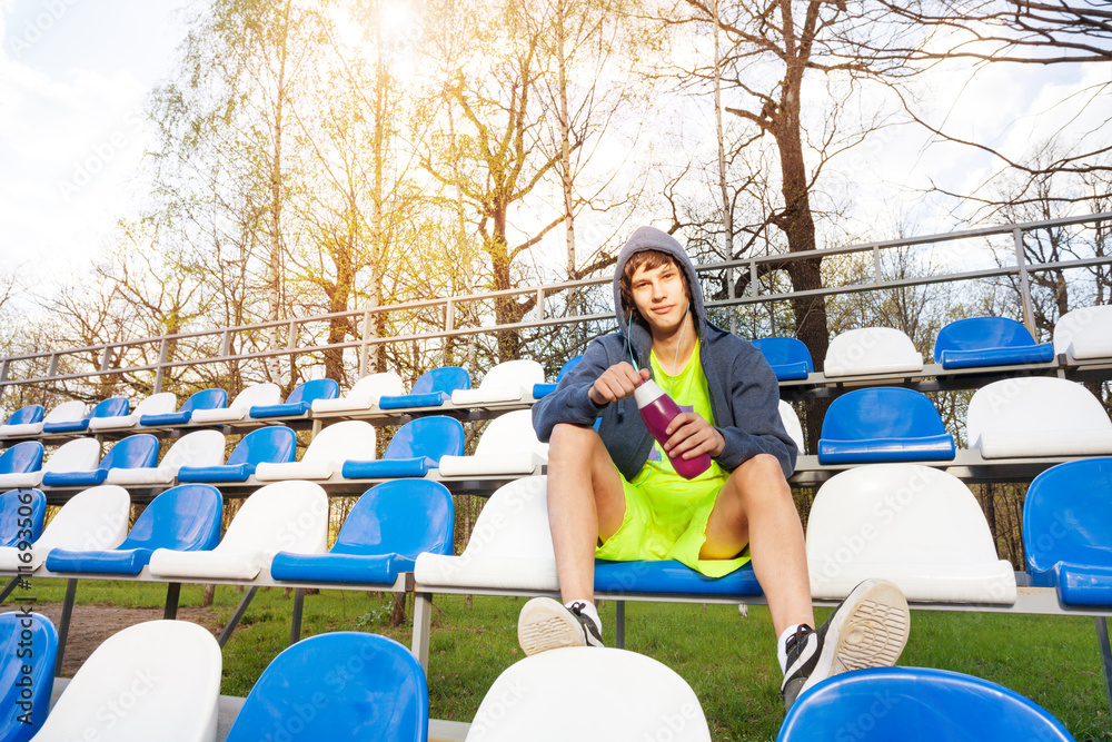 Teenage athlete having rest after working out