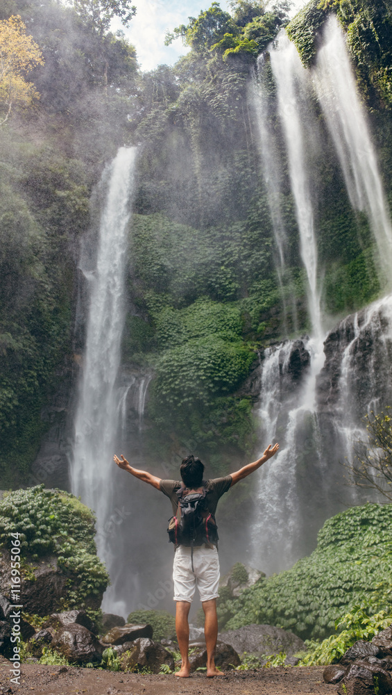 Male tourist enjoying view near waterfall