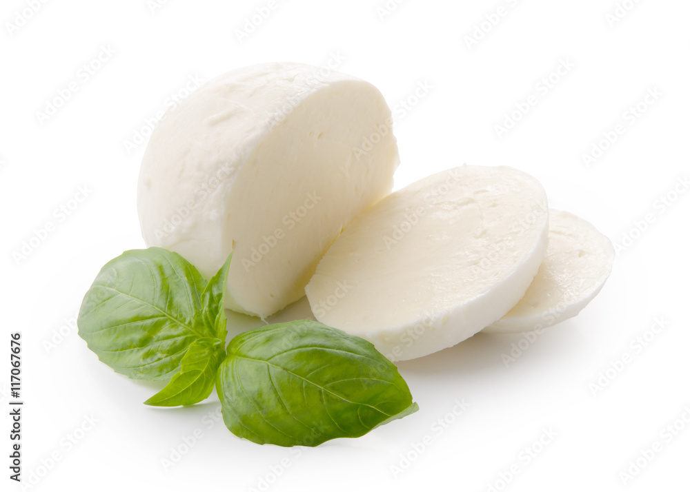 Piece of white mozzarella on white background. Decorated with basil.