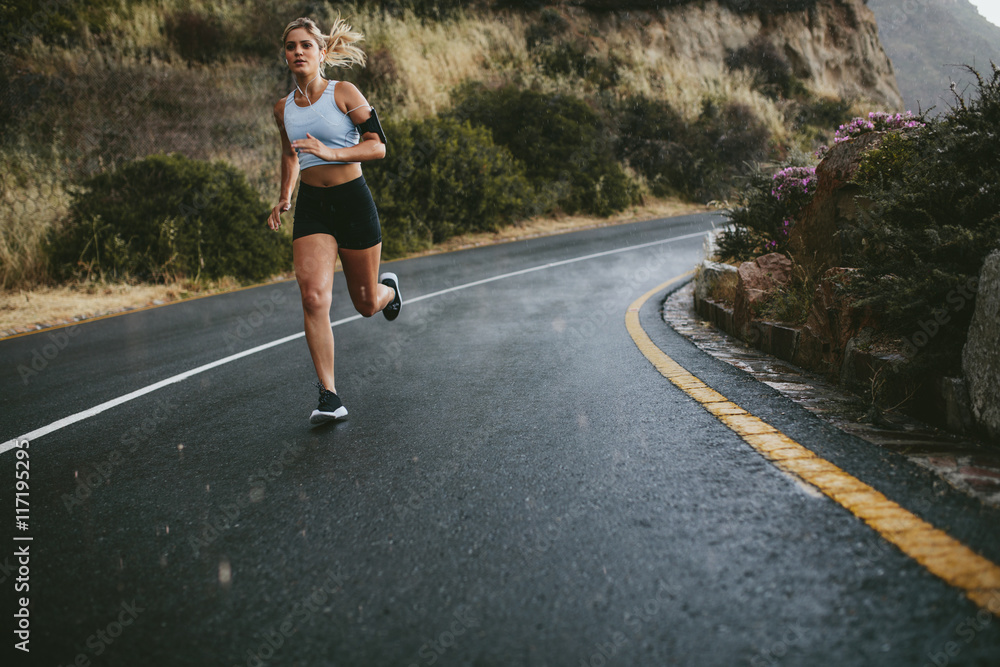 Young fitness woman running outdoors