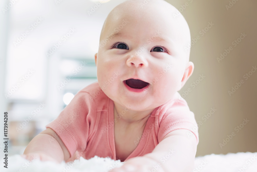 Happy newborn baby girl smiling