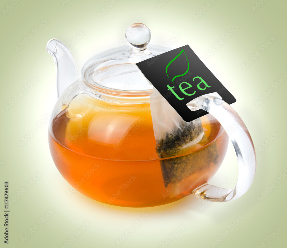 Teapot glass with tea bag isolated on a white background with clipping path. Front view.