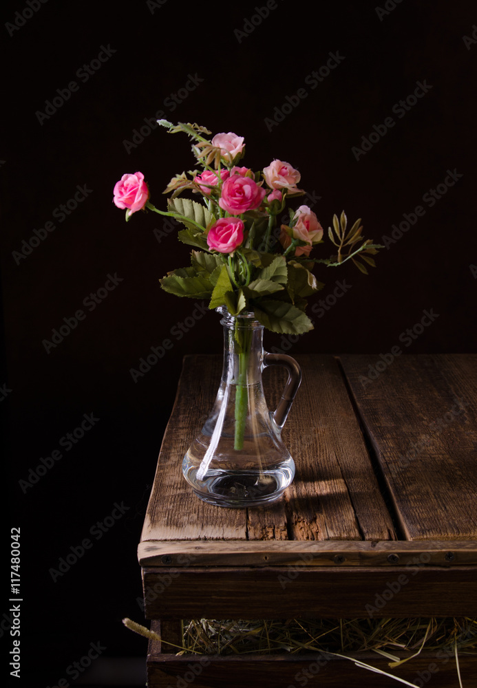 Bouquet of pink roses on wooden rustic background.