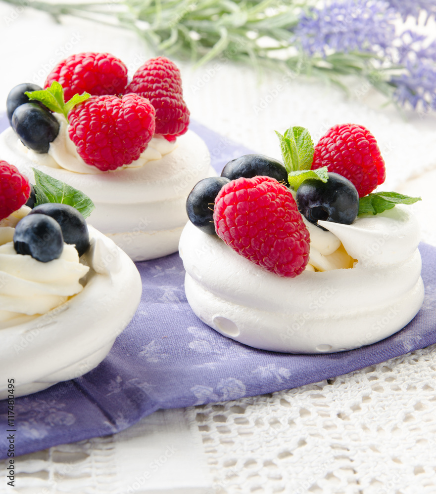 Homemade pavlova meringue cake with fresh berries and whipped cream. Morning. Dessert.