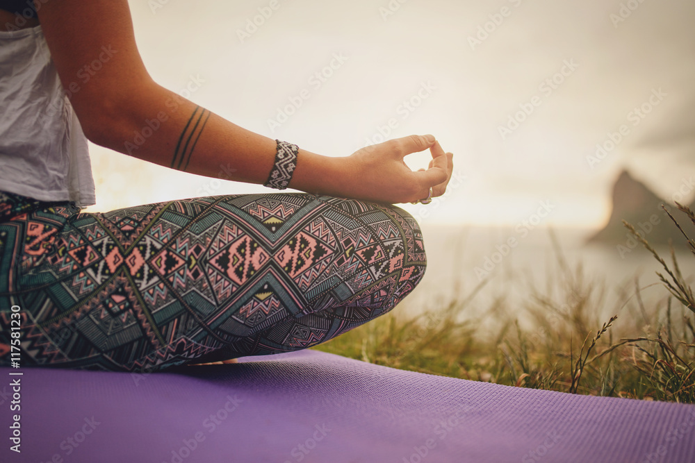 Young woman meditating outdoors