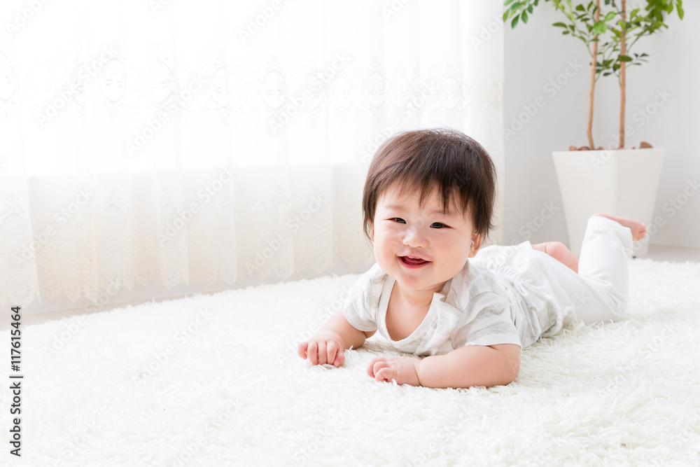 asian baby lying on the floor