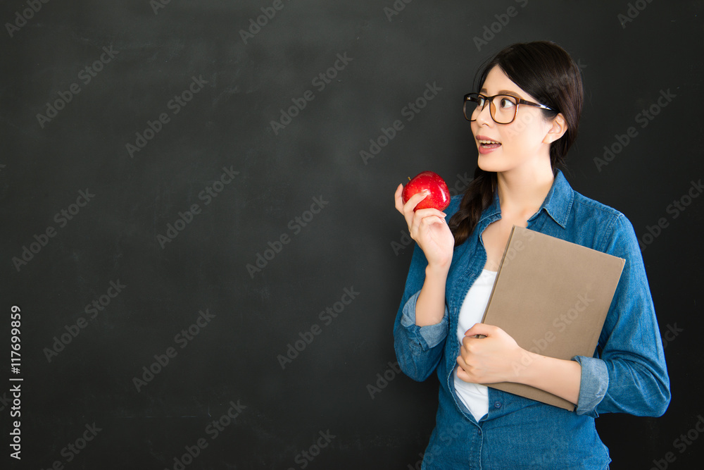 Young university student thinking in front of blackboard