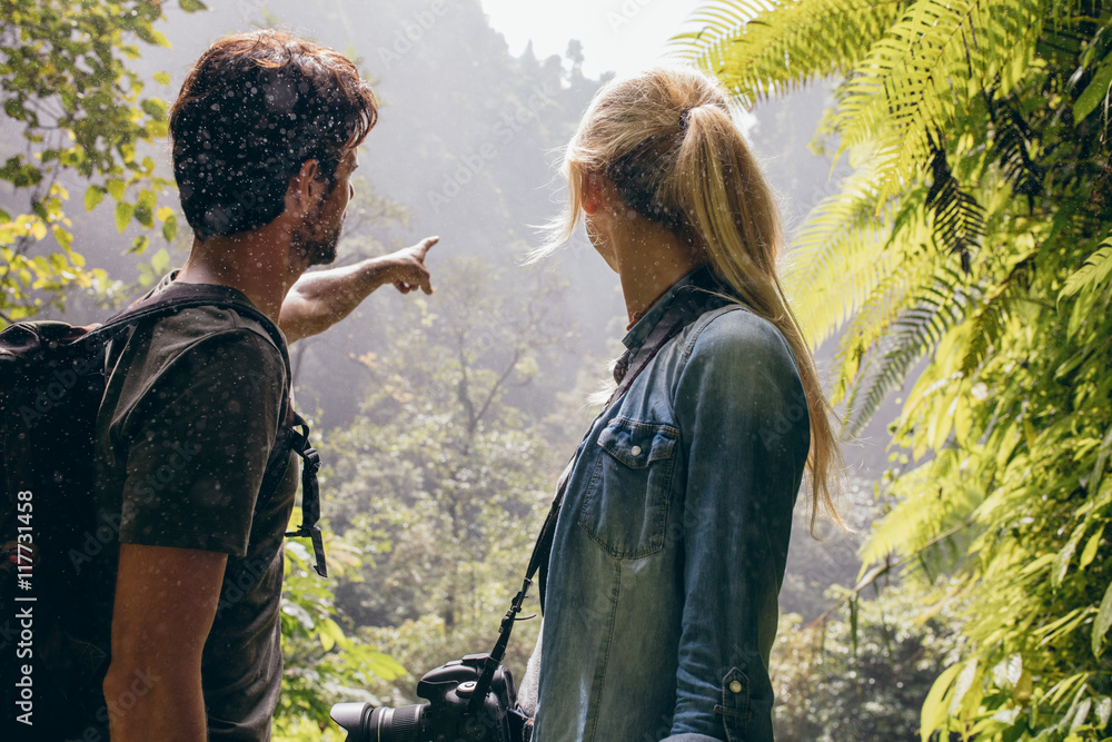 Young couple together looking into the forest