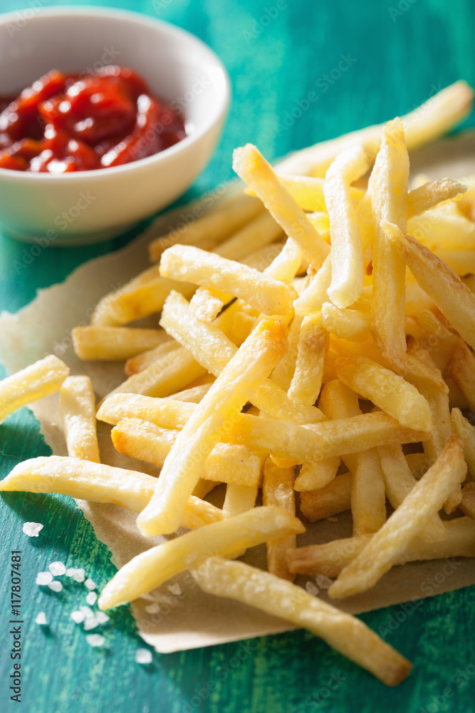 french fries with ketchup over green background