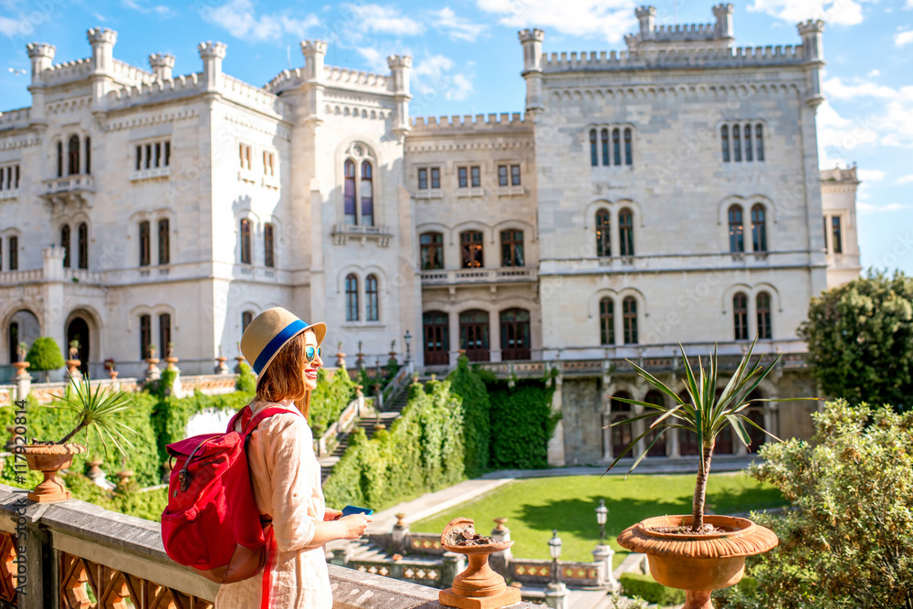 Young female traveler enjoying beautiful landscape near Miramare castle in northeastern Italy. Trave