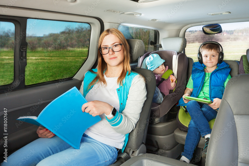 Portrait of mother and two sons sitting in the car