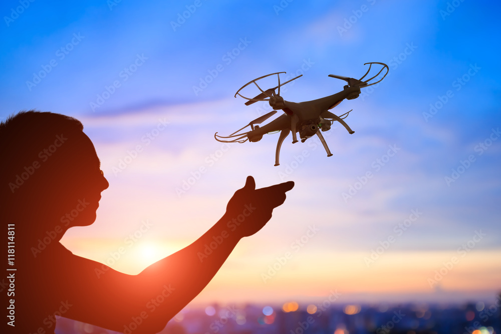 silhouette of man take drone