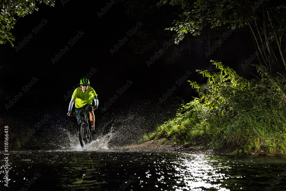 Mountain biker riding in forest stream