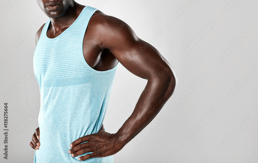 Muscular young african man standing with hands on hips