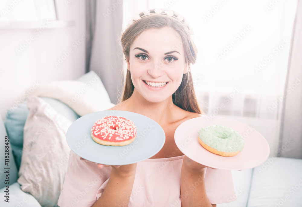 Woman look like princess at home with two donuts