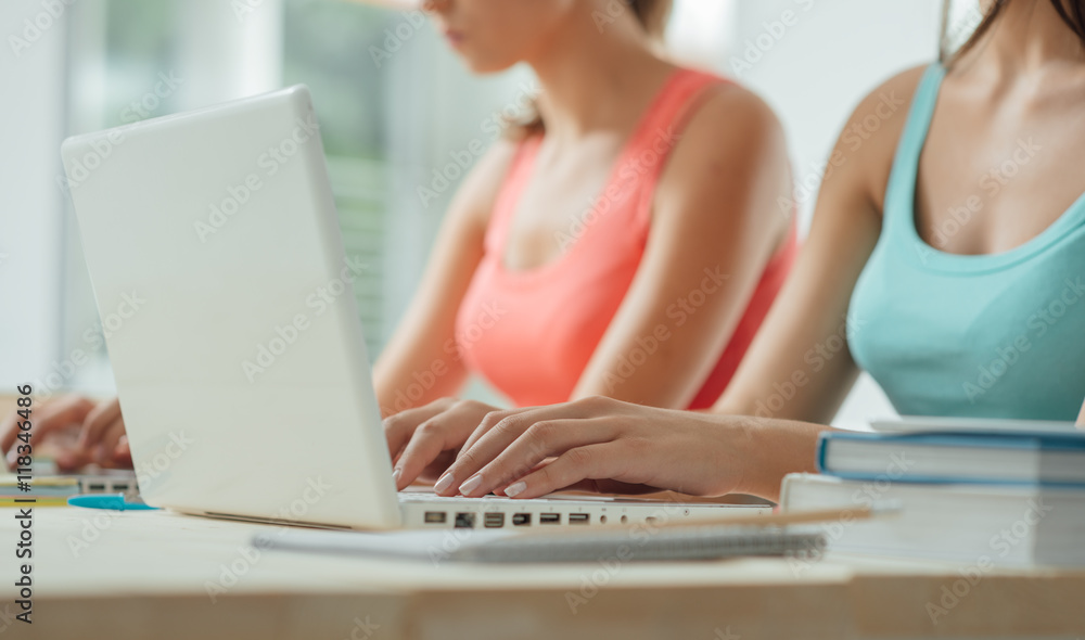 Students using laptops and studying