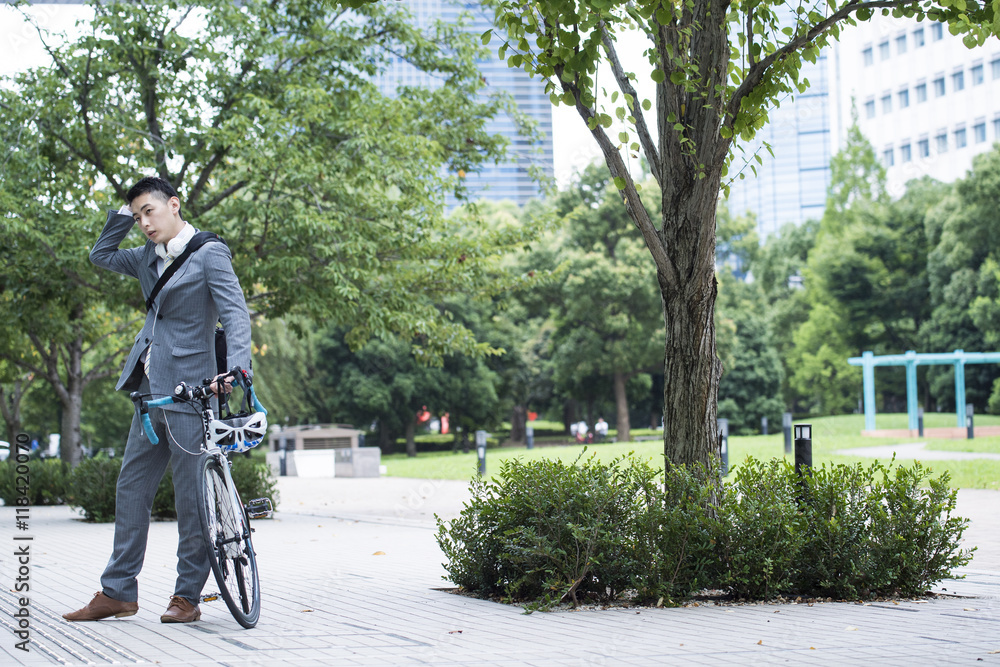 Young businessman has been commuting by road bike