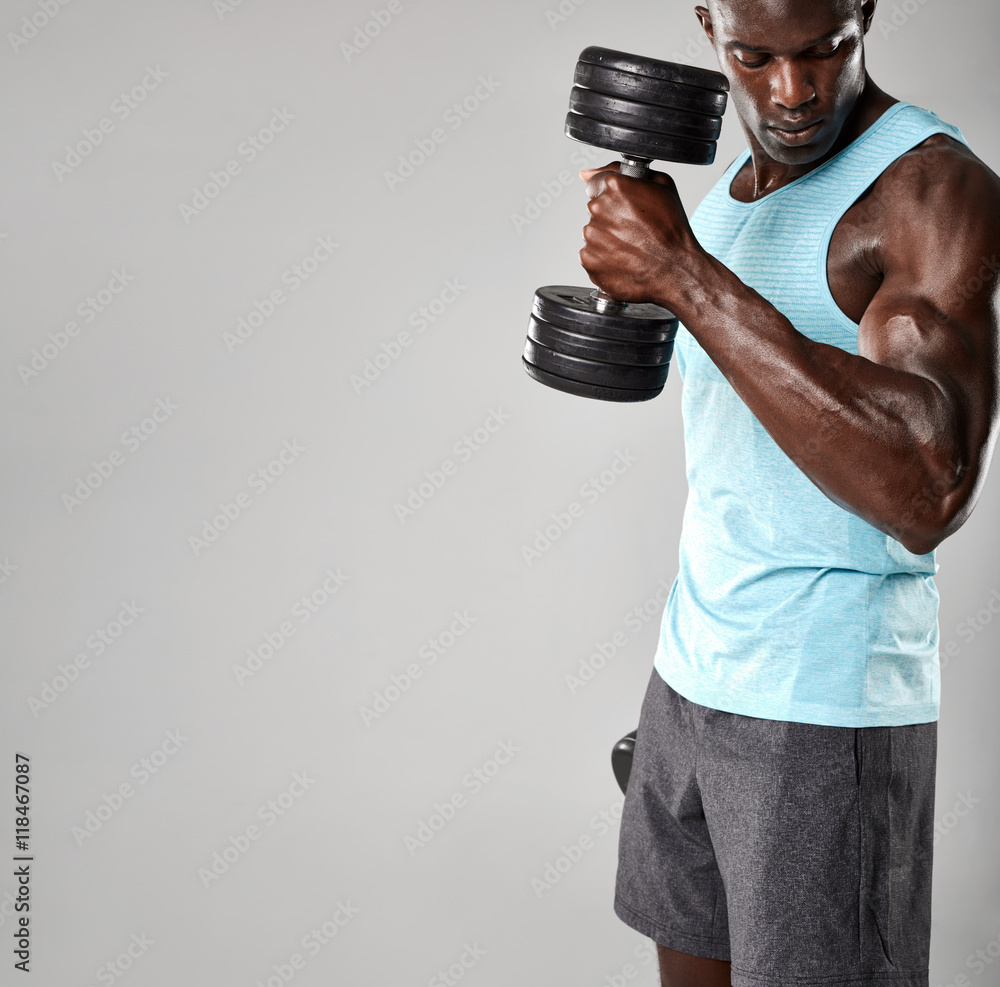 Young african man working out with dumbbells