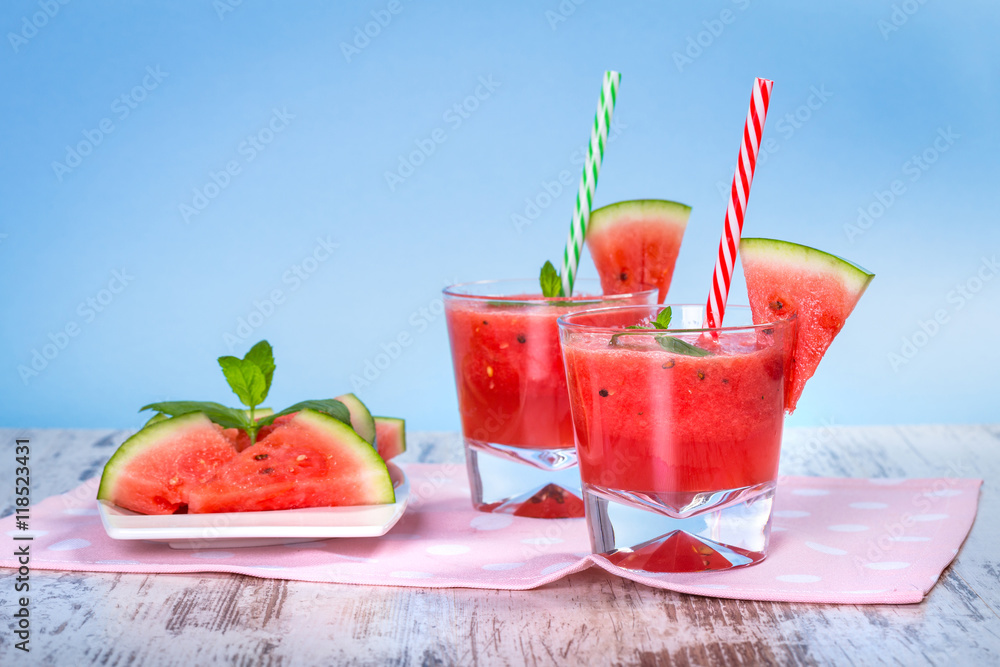 Glasses of watermelon smoothie on a wooden table