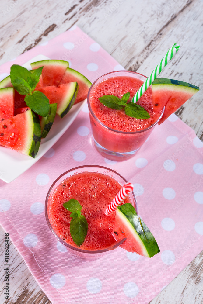 Glasses of watermelon smoothie on a wooden table