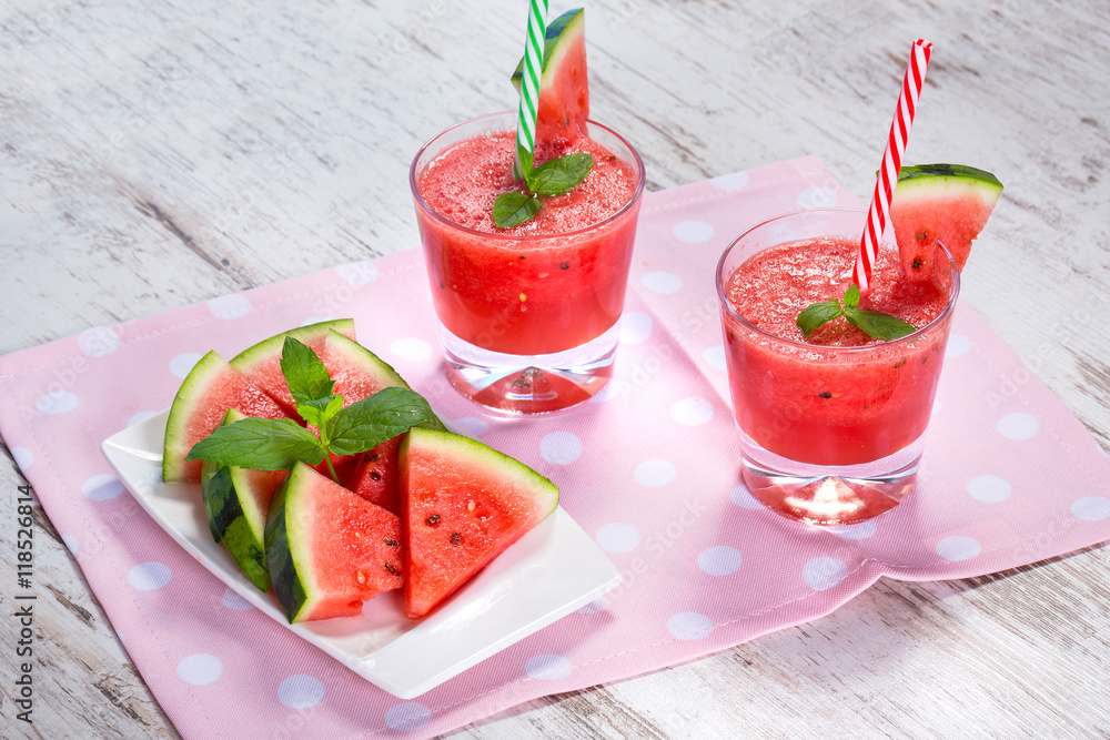 Glasses of watermelon smoothie on a wooden table