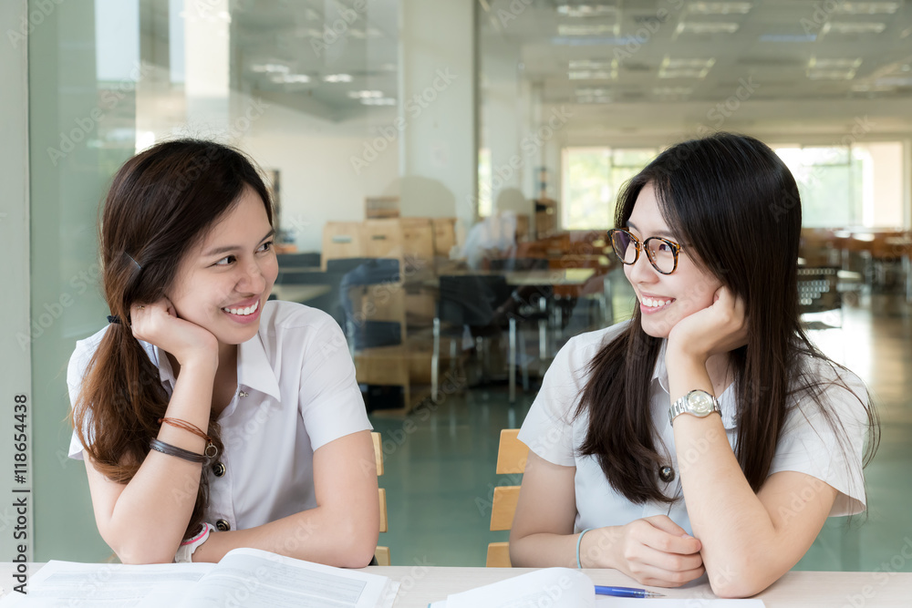 Two Asian student in uniform study in classroom. 