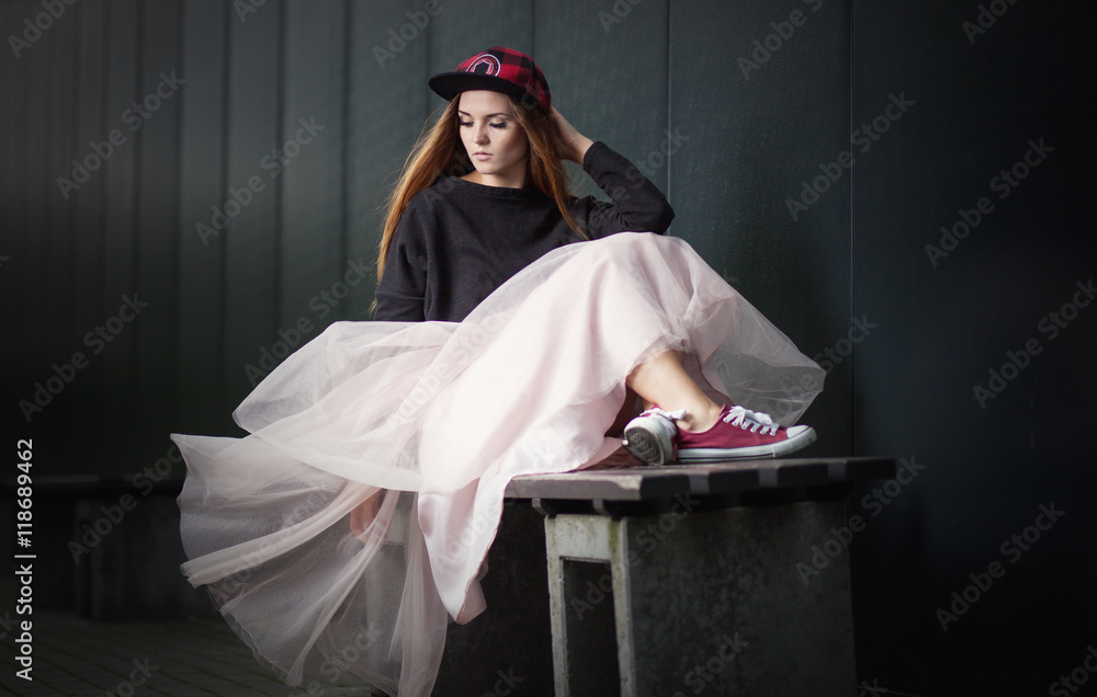 Trendy beautiful long haired girl posing, hip hop fashion