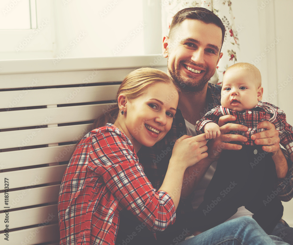 happy family mother and father playing with a baby