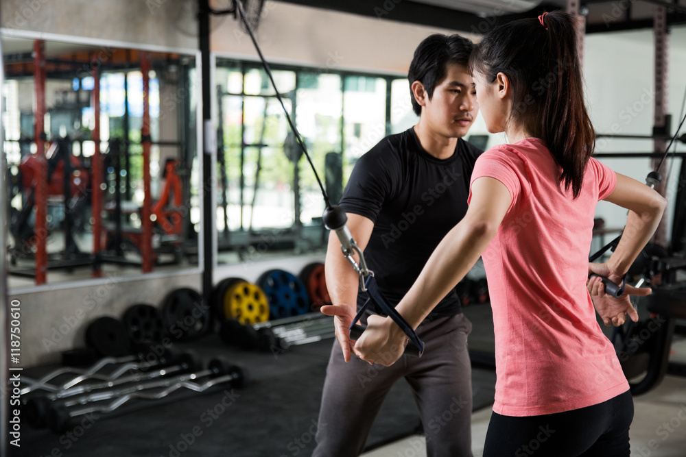 Trainer man are teaching Asian women Gym workout properly