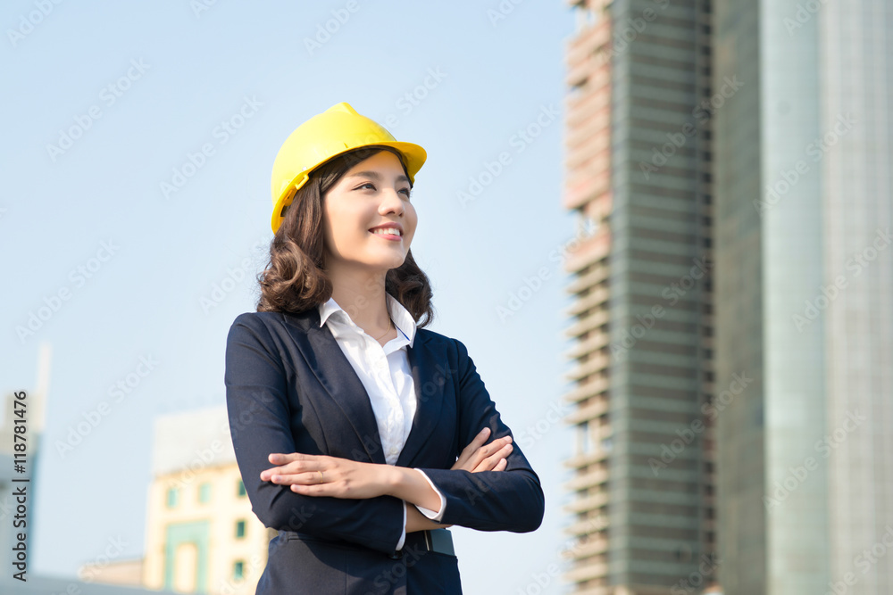 Young business woman using a tablet in the street with office bu