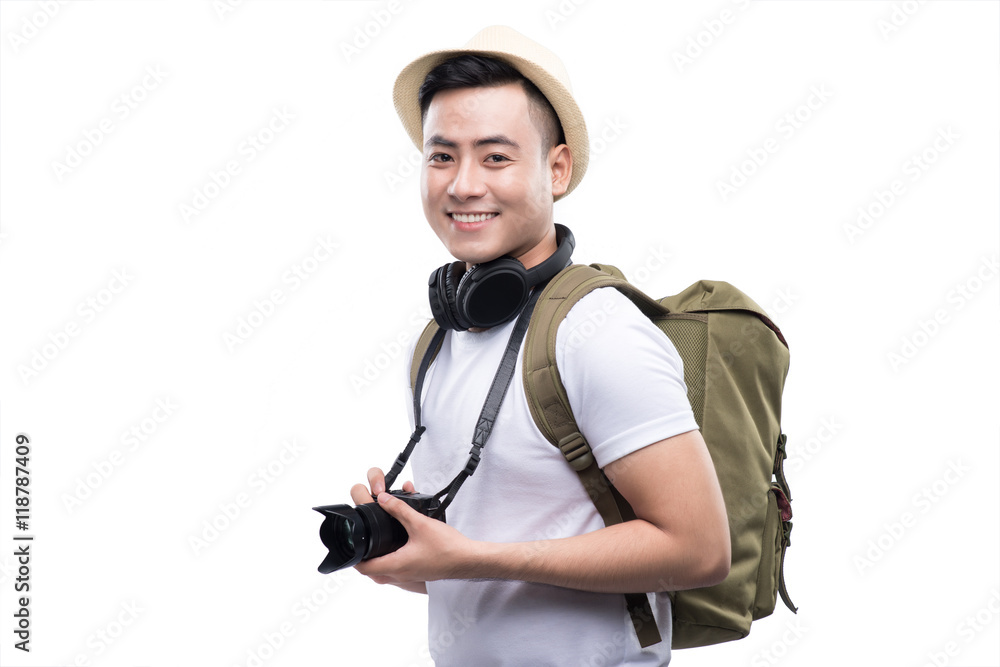 Travel concept. Studio portrait of handsome young man in hat wit