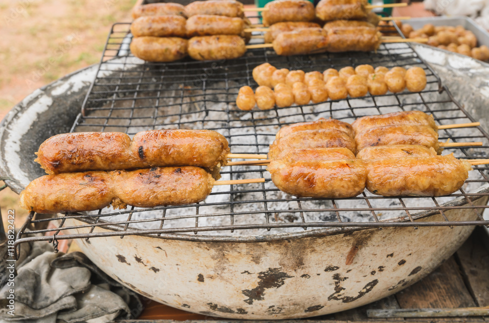 Display for sell BBQ with fiery sausages on the grill