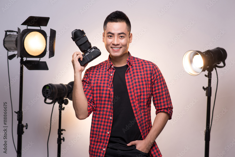 Professional photographer. Portrait of confident young man in sh