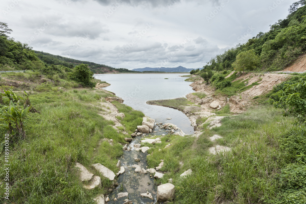 Peaceful stream flows through lush forest,and dams to store wate