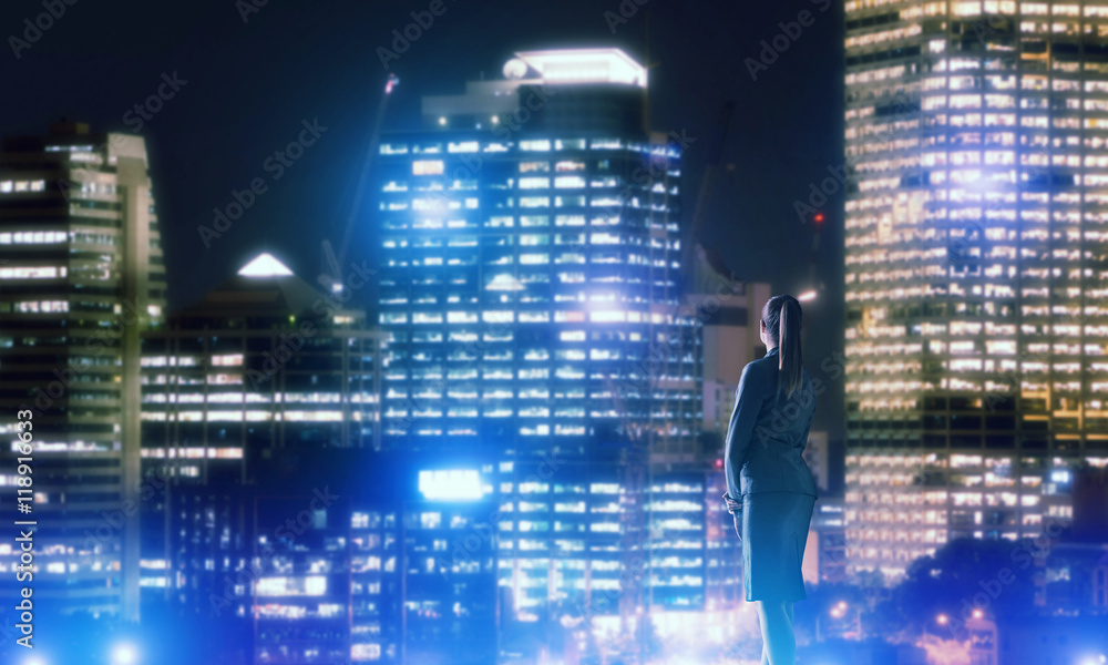 Woman looking at night city