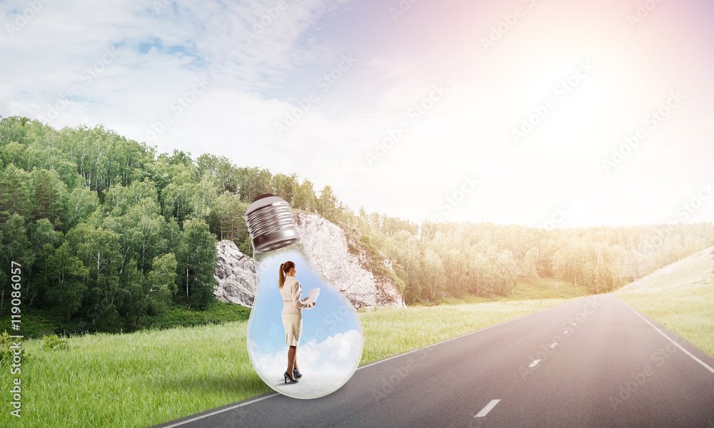 Businesswoman inside light bulb