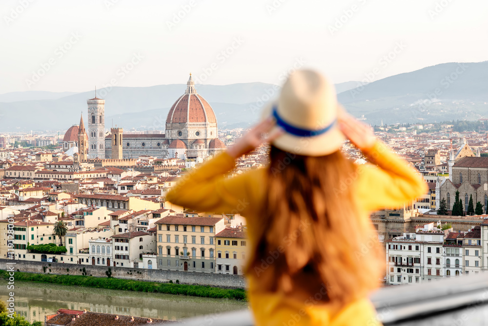 Young female tourist enjoying the view on the old town of Florence from Michelangelo square in the m