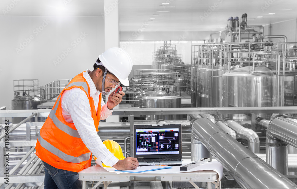 Industrial engineer using laptop computer in the factory