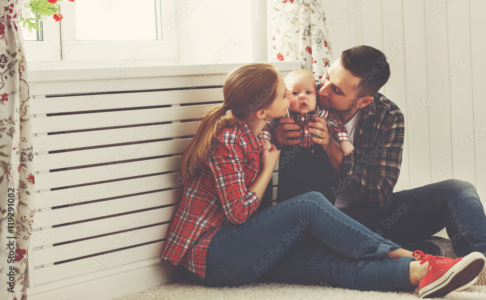 happy family mother and father playing with a baby