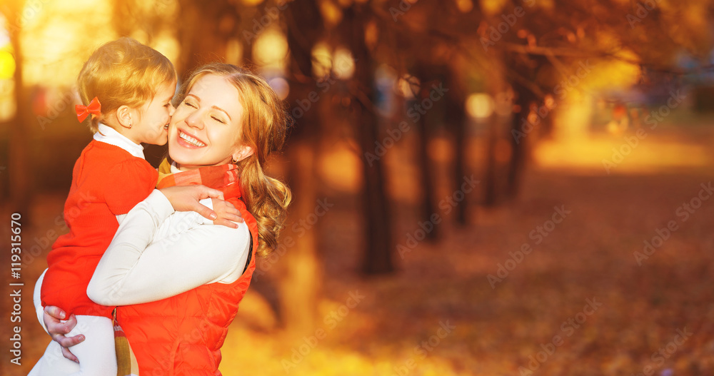 happy family. mother and child little daughter play kissing on a