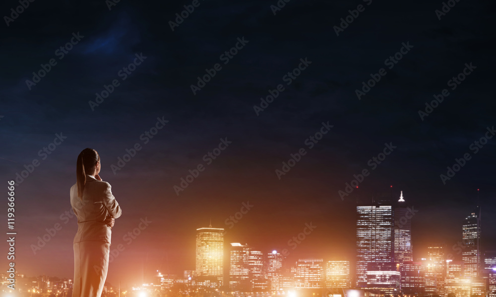 Woman looking at night city