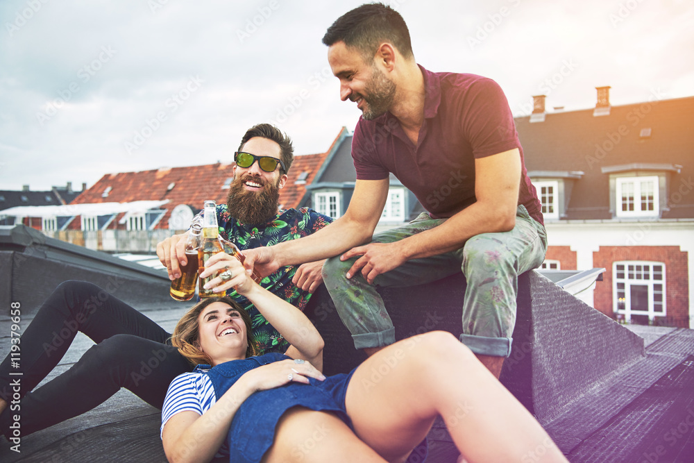 Three adults enjoying beer and friendship