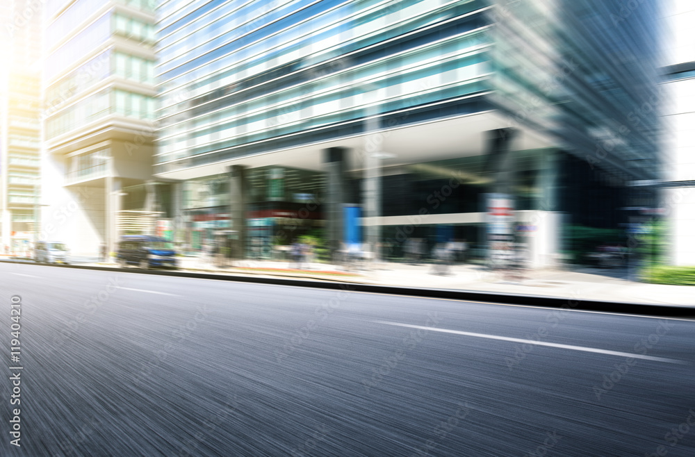 modern office buildings in tokyo from urban road with sunbeam