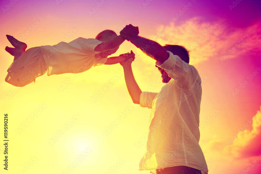 Father with his little son playing together outdoor