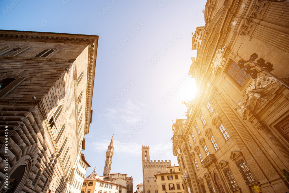 Florence cityscape view with Badia Fiorentina church tower and San Firenze complex on the sunset in 