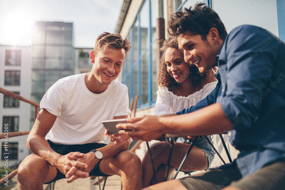 Group of people watching video on the mobile phone