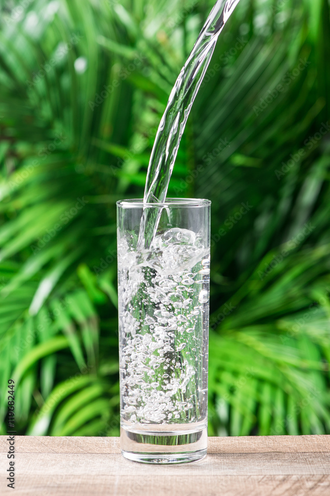 Glass of water on nature background.