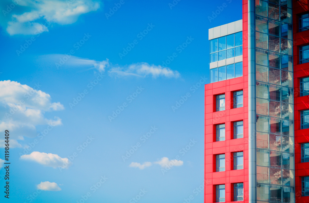 modern building on a background of blue sky with clouds